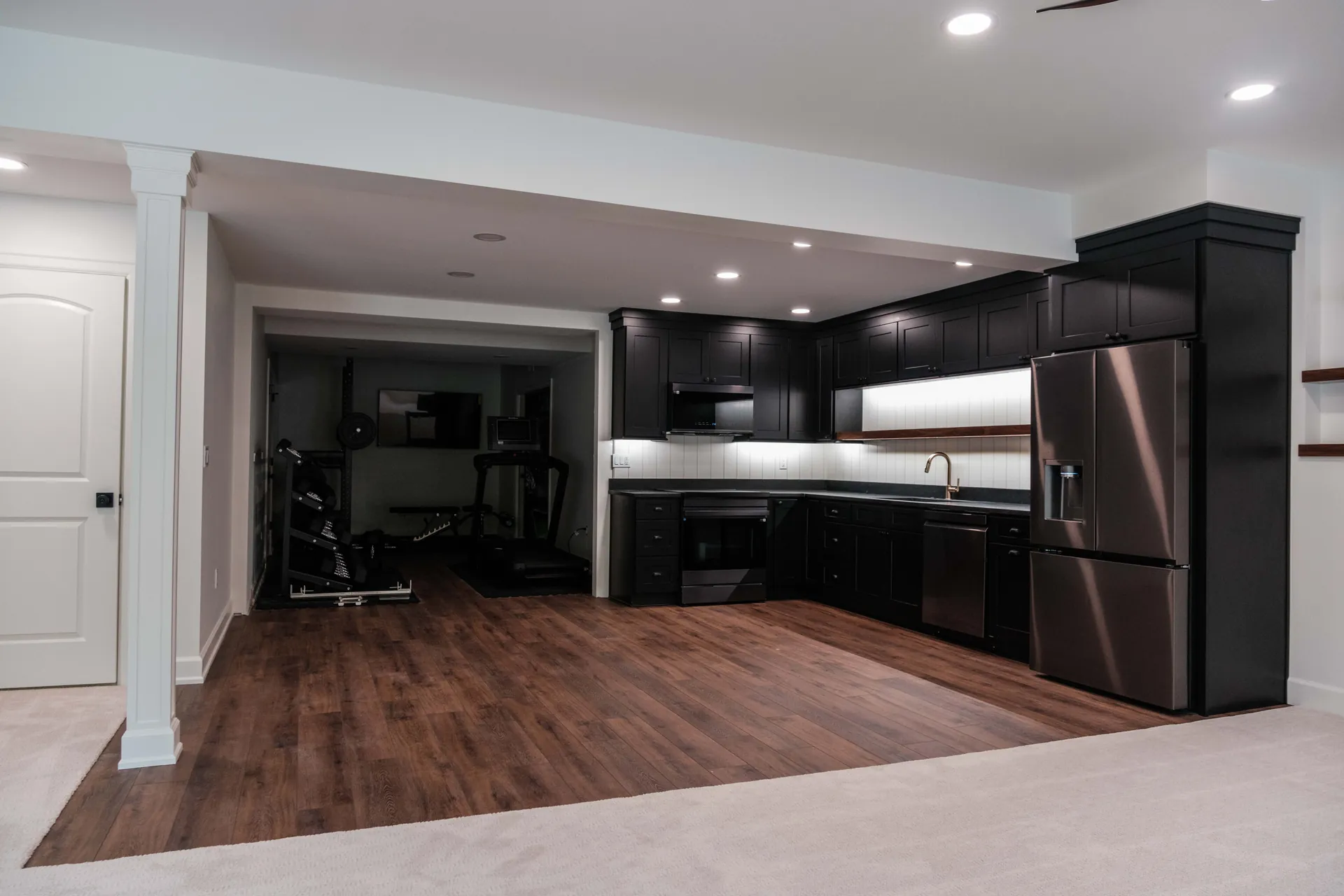 Finished open-plan basement remodel with kitchenette and living space, Greater Lansing